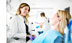 Dentist sitting and talking with patient Dental Coach